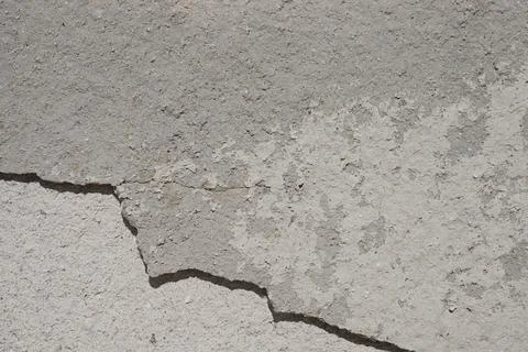 Old gray wall with cracks Stock Photos