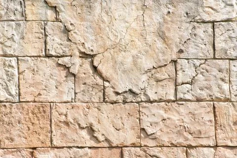 Old gray wall of rectangular stone blocks with remnants of plaster. Abstract  스톡 사진