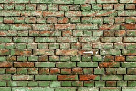 Old green brick wall, rustic texture, design background. Stock Photos