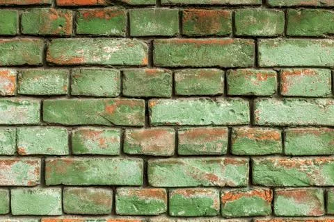 Old green brick wall, rustic texture, design background. Stock Photos