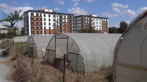 Old green-houses and new modern buildings Stock Footage