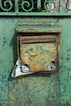 Old green mailbox with mail Stock Photos