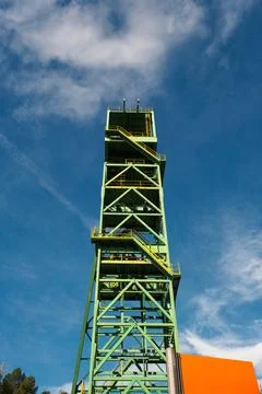 Old green mining tower with the sky in the background. Stock Photos