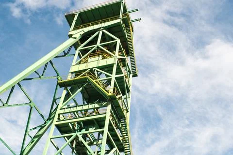 Old green mining tower with the sky in the background. Stock Photos