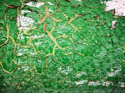Old green paint is much cracked. Background texture closeup. Stock Photos