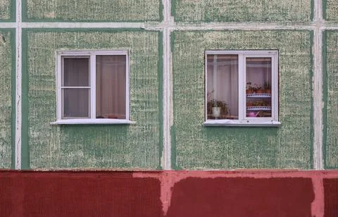 The old green panel house. Two windows Stock Photos