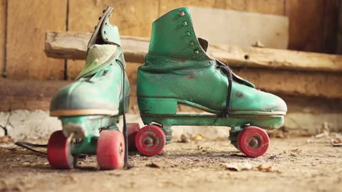 Old green roller skates with red wheels in shed / front and side view 動画素材 130886057