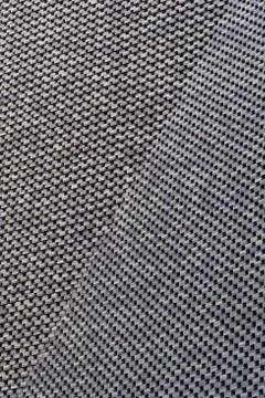 Old grey brick wall pattern with a bend in the architecture. Stock Photos