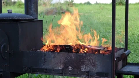 Old grill for cooking meat with a burning fire Stock Footage 158431852