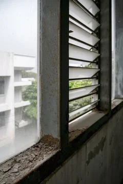 Old grunge rusty window, viewed from interior with bright light from outside Stock Photos