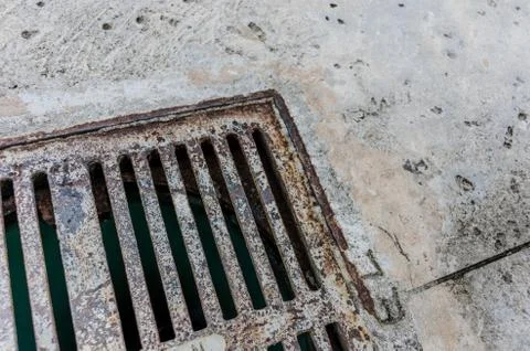 Old gutter on sidewalk Stock Photos