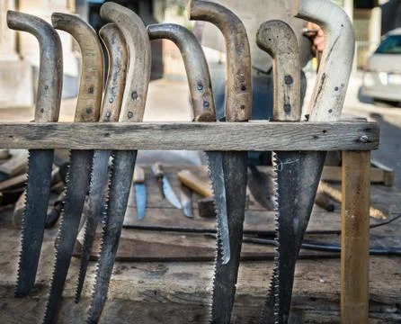 Old hacksaws handmade using the worn blades of scythes. Stock Photos
