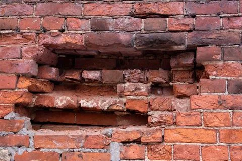 Old half destroyed stone wall of red bricks Stock Photos