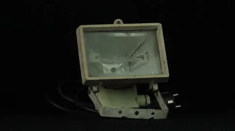 Old halogen lamp rotates on a black background loop Stock Footage 34660583