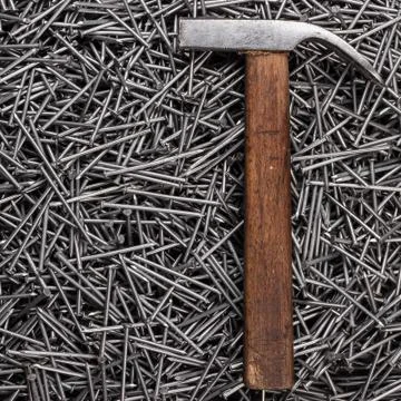Old hammer and nails on table Stock Photos