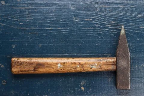 Old hammer on blue table Stock Photos