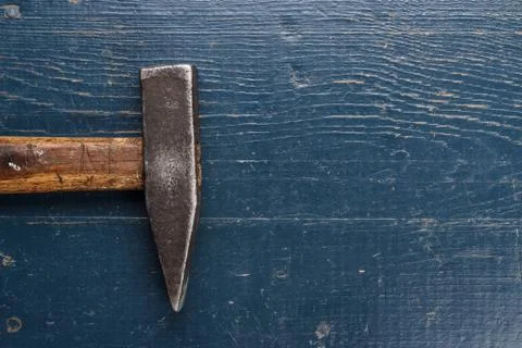 Old hammer on blue table Stock Photos