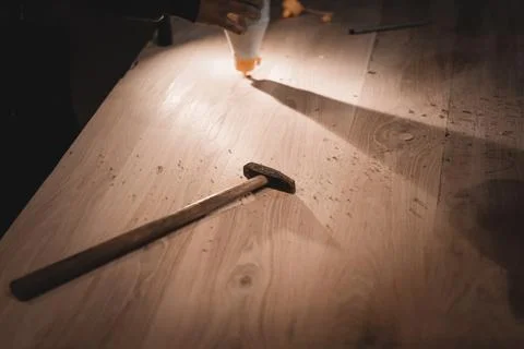 An old hammer with a long handle. Small working tools of a carpenter on a dus Stock Photos