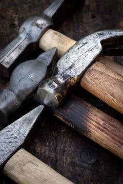 Old hammers on a wooden workbench Stock Photos