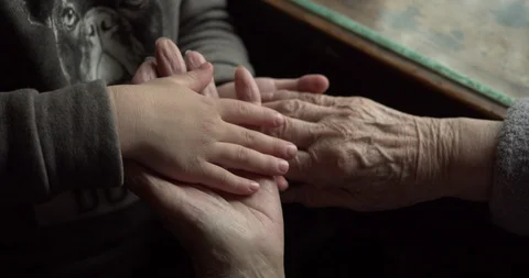 The old hand grabs the young one. a game between generations. high five Stock Footage 130049246