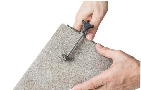 Old hand tile cutter for small repair on the white background Stock Photos