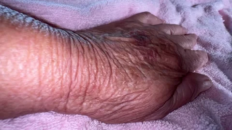 Old hand with wrinkles on the fluffy material Stock Footage 222198233