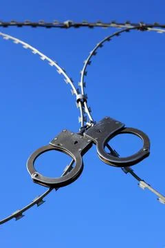 Old Handcuffs On Razor Wire Stock Photos