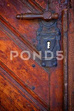 Old handle in wooden doors - frontal view Stock Photos