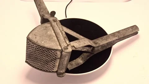 Old handmade galvanized potato ricer Stock Footage 336980563