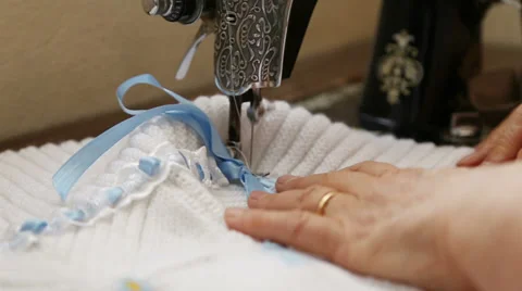 Old hands are sewing with machine 2 Stock Footage 37182298