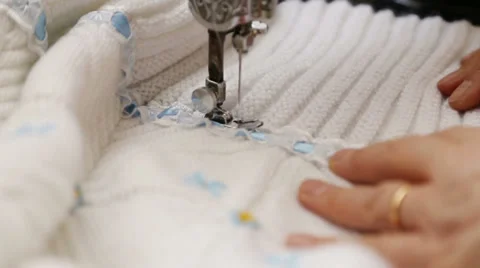 Old hands are sewing with machine. Stock Footage 37199188