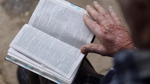 Old hands browsing the bible Stock Footage 127525571