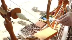 A woman making yarn from wool on a foot , Stock Video