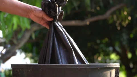 Old hands holding garbage in to a bin , protect environment from a pollution Видео 158532720