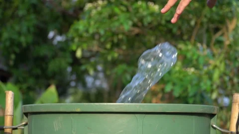 Old hands holding garbage in to a bin , protect environment from a pollution Видео 158589838