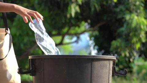 Old hands holding garbage in to a bin , protect environment from a pollution Видео 158589866