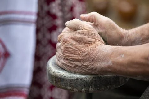 The old hands of the master make products from clay. Work on the potter's w.. Stock Photos