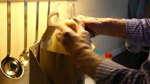 Old hands peeling an Onion Stock Footage 68978299