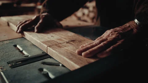 Old hands working with a circular saw cutting wood in straight line Stock Footage 139754822