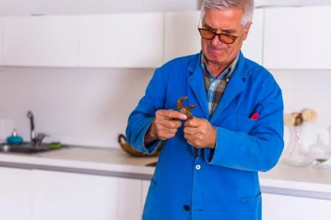 Old handyman working with tools Stock Photos