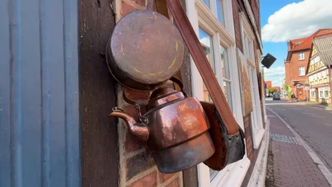 Old Hanging Cookware on Building Wall Beside Urban Street Video stock 341885721