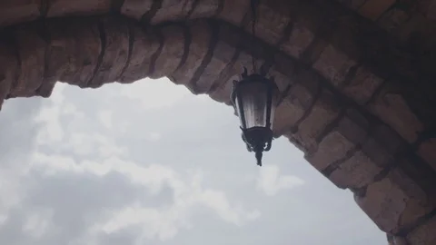 Old hanging lantern on brick wall Stock Footage 77090869