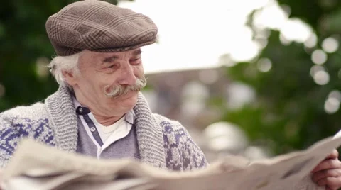 Old happy man reading papers Stock Footage 62549477