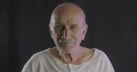 An old happy senior man is dancing on studio shot. Portrait of retired elderly Stock Footage 136762747
