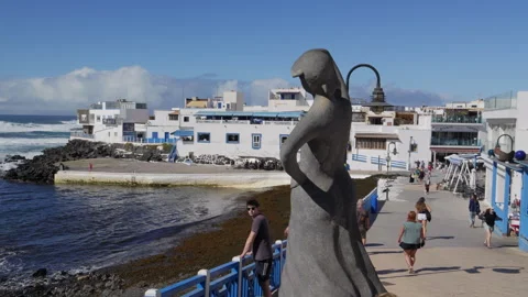The Old Harbour in El Cotillo and a statue Monument to fisherman Stock Footage 302309825