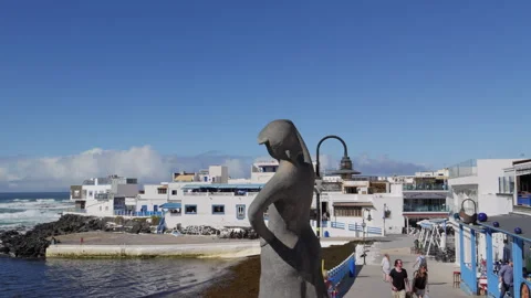 The Old Harbour in El Cotillo and a statue Monument to fisherman Stock Footage 302309844