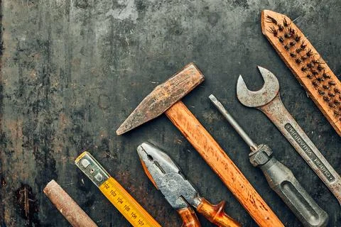 Old hardware tools. Wrench, screwdriver, measure, hammer, pliers on steel s.. Stock Photos