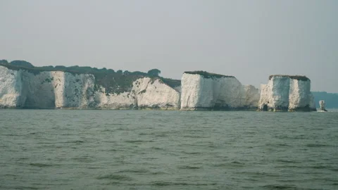 Old Harry and chalk cliffs on a hazy day. Cloudy day shot of chalk cliffs Stock Footage 137977058