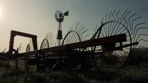 An Old Hay Rake and Wind Pump in a Rural... | Stock Video | Pond5