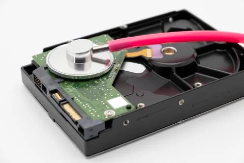 Old HDD or hard disk drive antique storage with pink stethoscope Stock Photos
